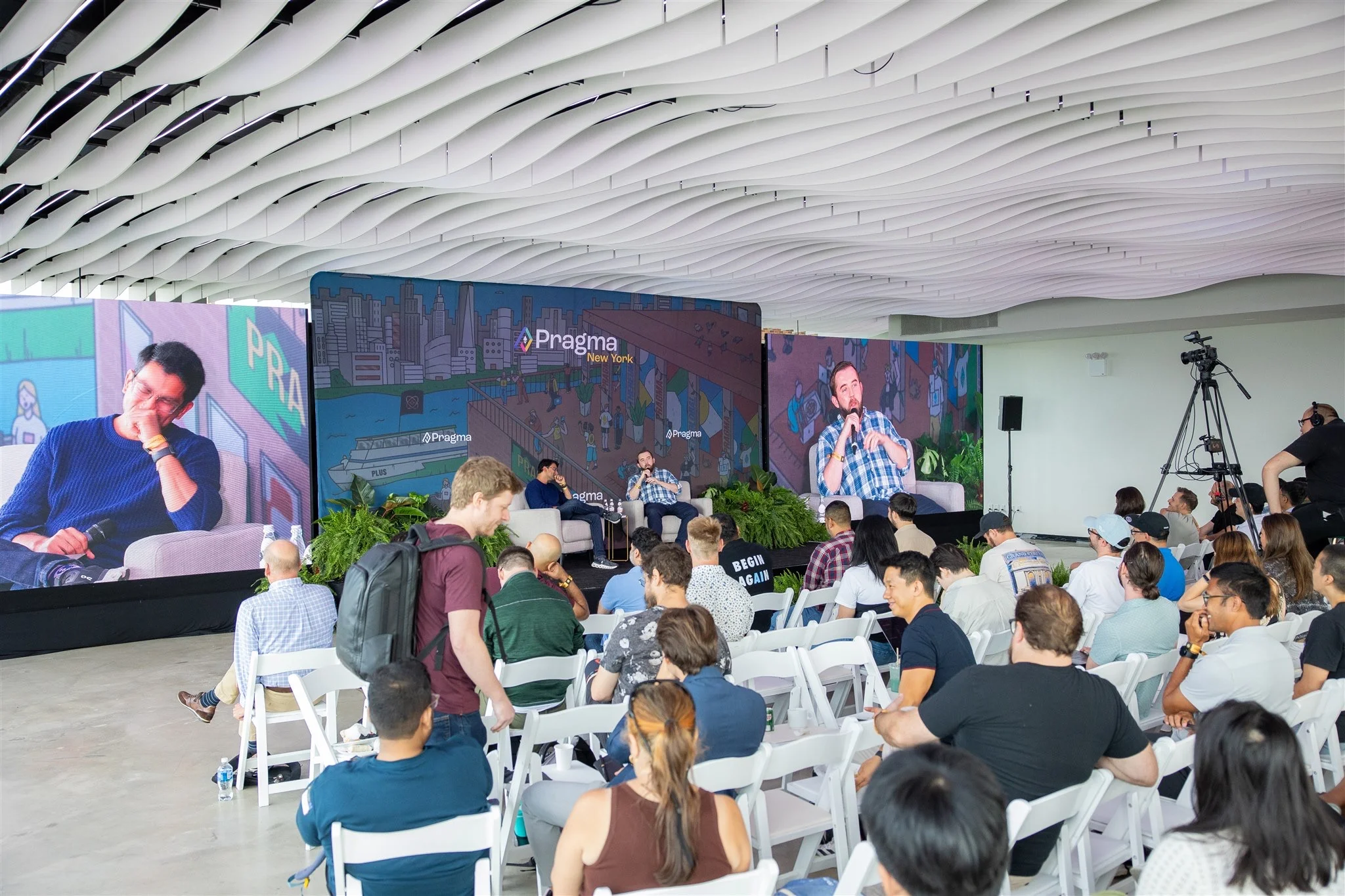 Conference panel session on the speaker stage at VESPER, a venue for interactive conferences in Brooklyn, NYC