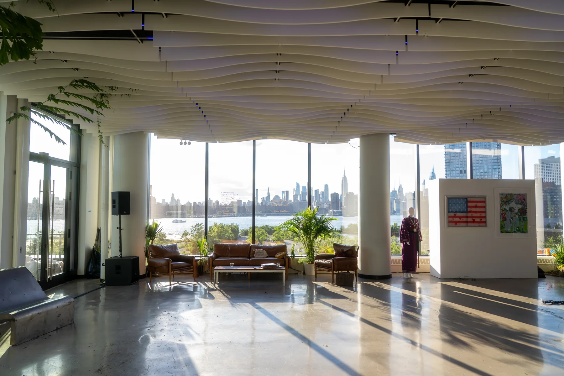 Corporate retreat setup at VESPER with floor-to-ceiling windows and Manhattan skyline views from the Williamsburg waterfront