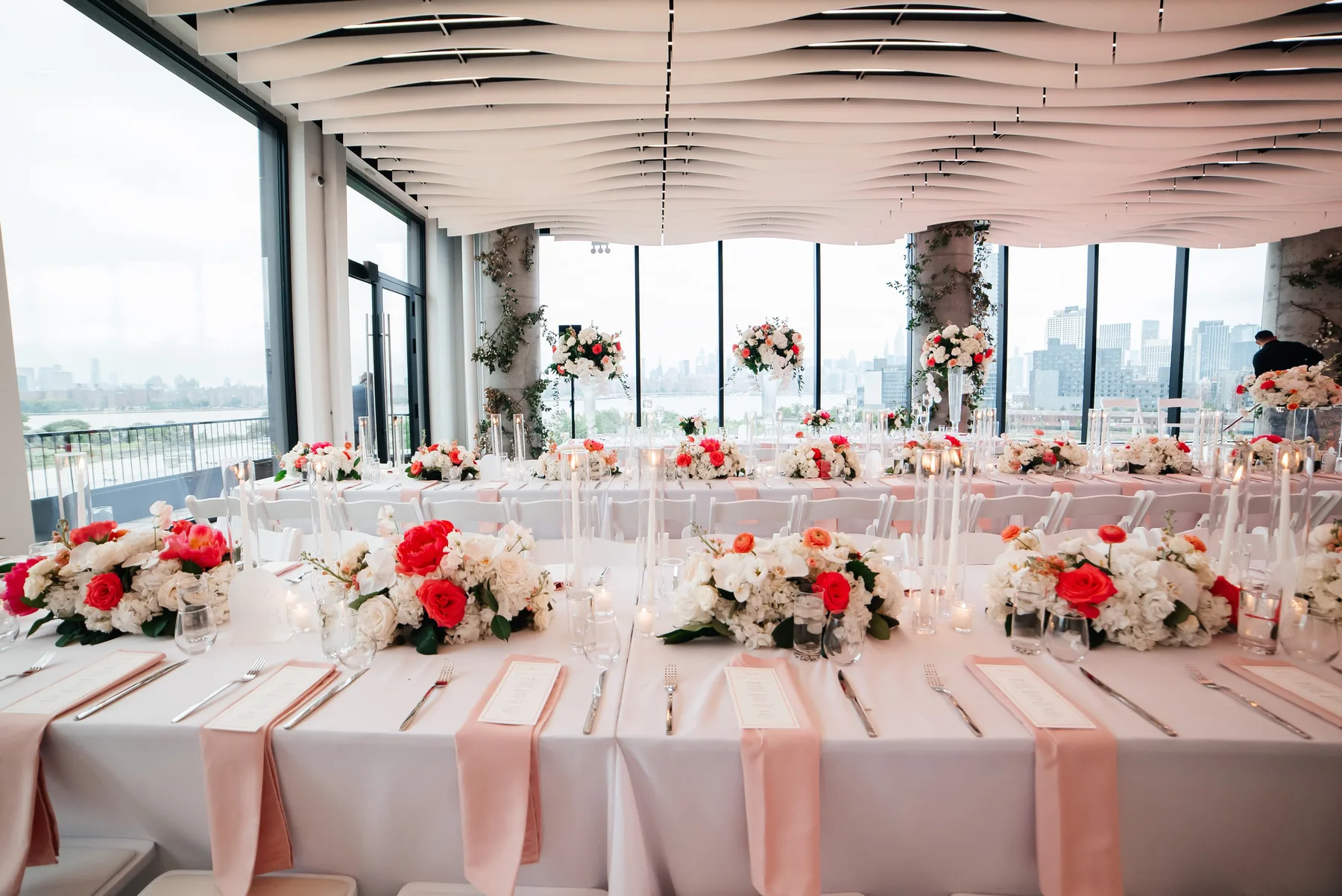 Modern wedding ceremony setup at VESPER in Brooklyn with the distinctive wave ceiling and panoramic skyline views