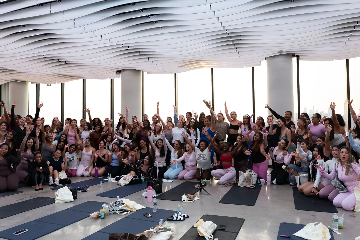 The full group at a VESPER wellness event gathered for a photo on the main floor in Brooklyn