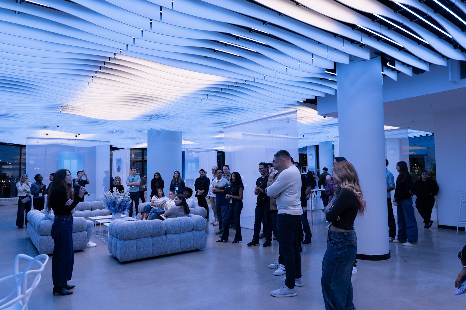 Guests filling the lounge under the blue-lit wave ceiling at VESPER