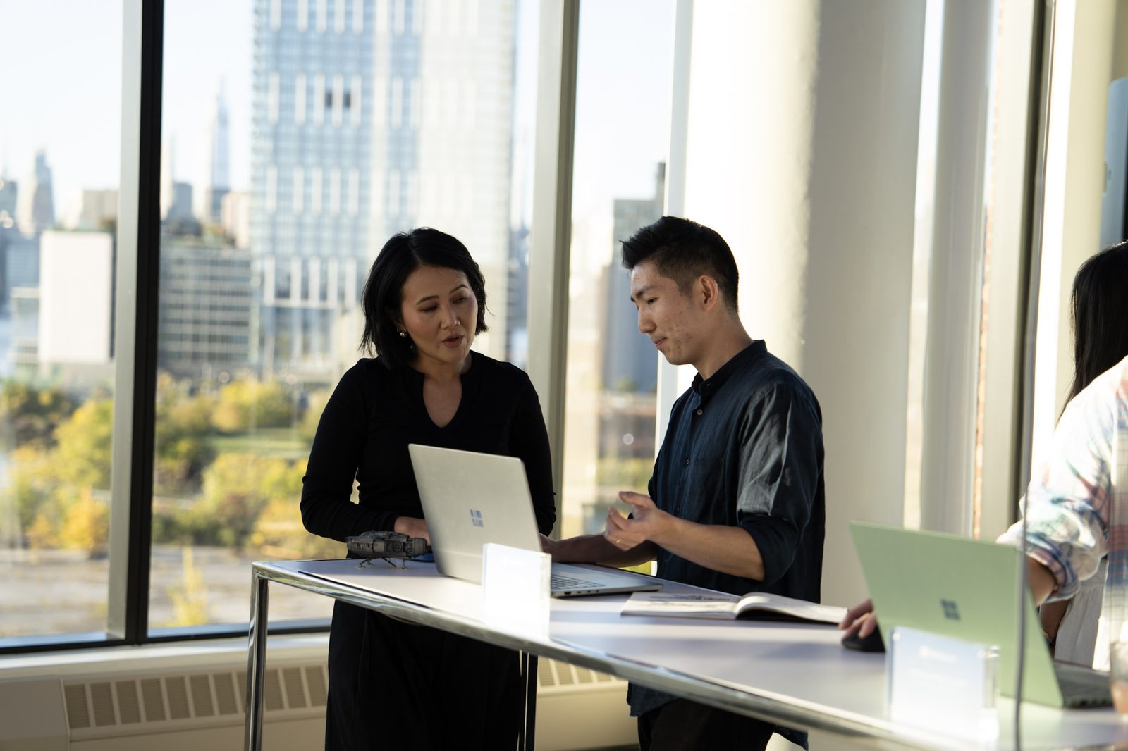 Guests at a Surface demo table by the windows at VESPER