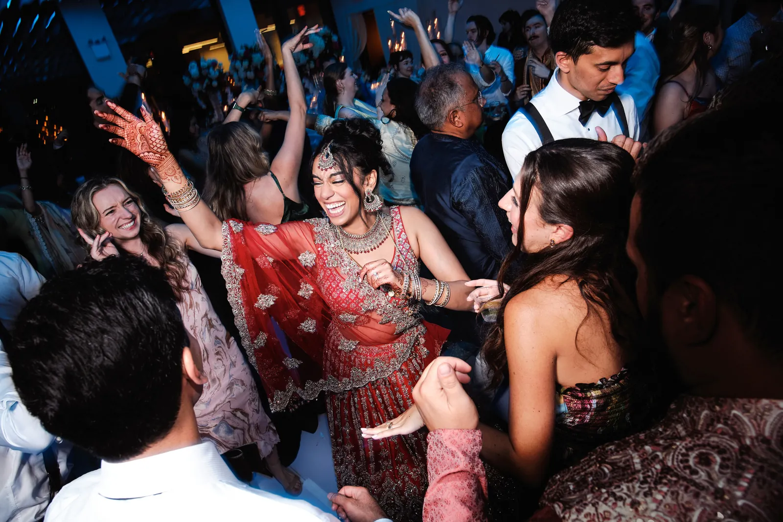 Bride and guests dancing together at a wedding reception at VESPER